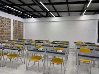 Salón con pupitres de la Escuela La Holanda
